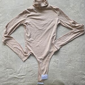 Shop Boyed Ribbed Turtleneck Bodysuit with Thumbholes - Oatmeal
